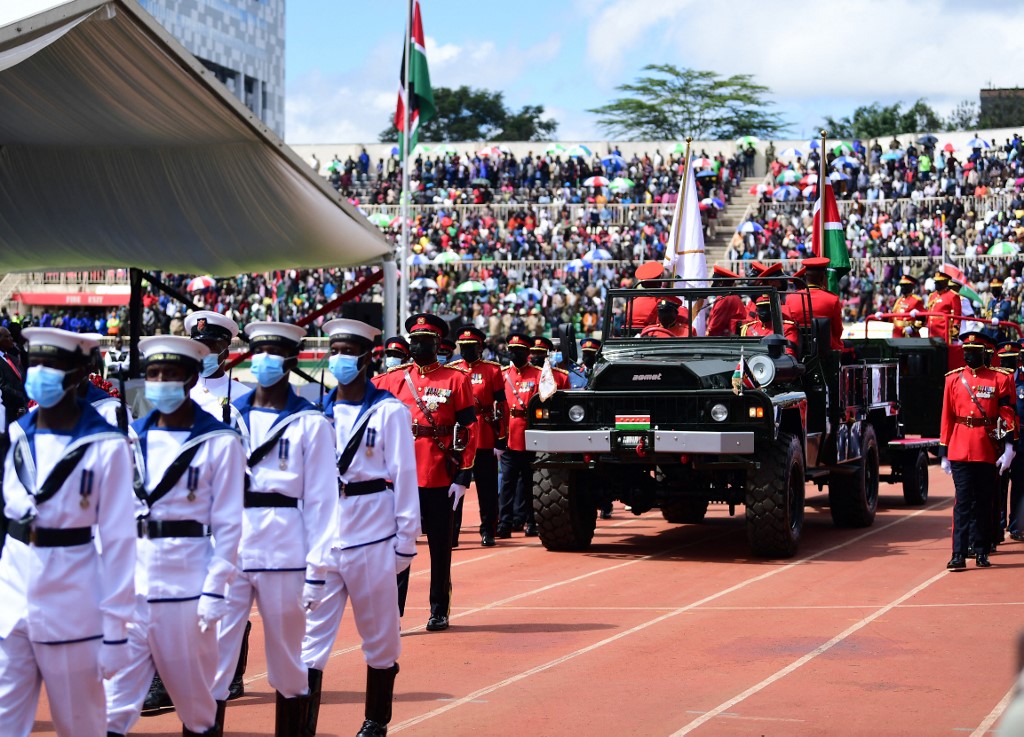 The casket carrying the remains of former Kenyan President Mwai Kibaki arrives in his cortege for his memorial service at the Nyayo National Stadium in Nairobi on April 29, 2022. — AFP pic
