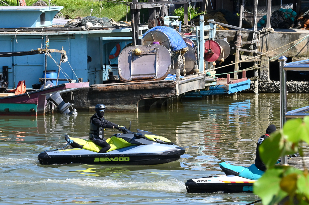 Rescue volunteers ride jet skis on the Mersing river during the search to locate three missing divers in Mersing, Johor, April 8, 2022, after they disappeared off Malaysiau00e2u20acu2122s south-east coast. u00e2u20acu201d AFP pic 