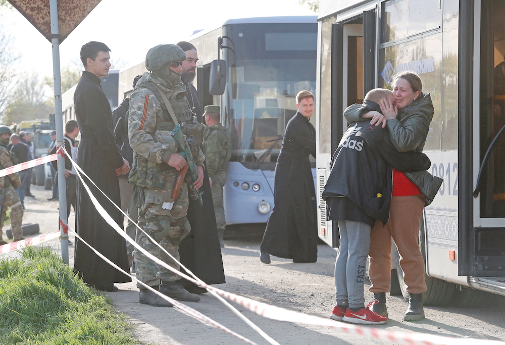An Azovstal steel plant employee hugs her son, who had earlier left the city with his relatives, as they meet at a temporary accommodation centre in the village of Bezimenne, Ukraine May 1, 2022. u00e2u20acu201d Reuters pic