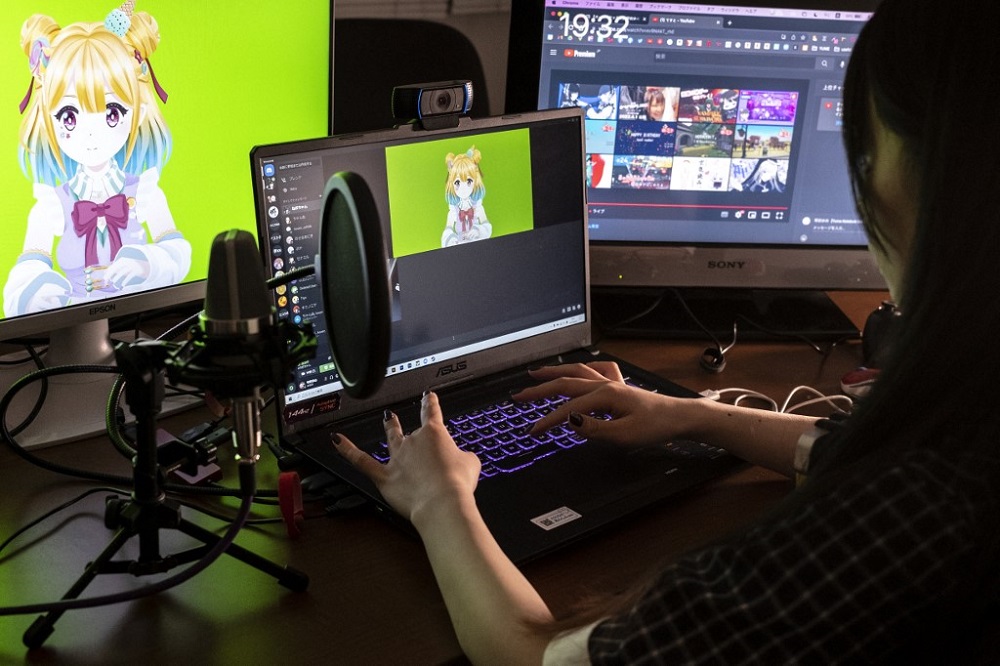 Mayu Iizuka, a virtual YouTuber who voices and animates a character called Yume Kotobuki, preparing for a livestream at a studio in Tokyo April 7, 2022. — AFP pic