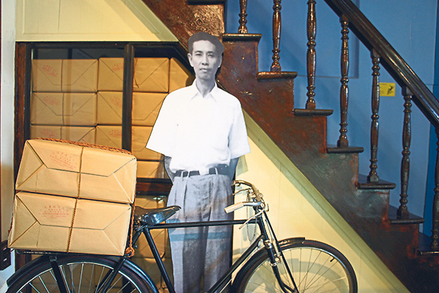 A cut out of the ‘Cycling Entrepreneur’ next to a vintage Japanese bicycle