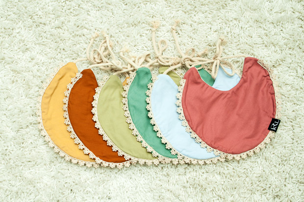Pastel hued Exclusive Bibs by thelittlekrl have lace details.