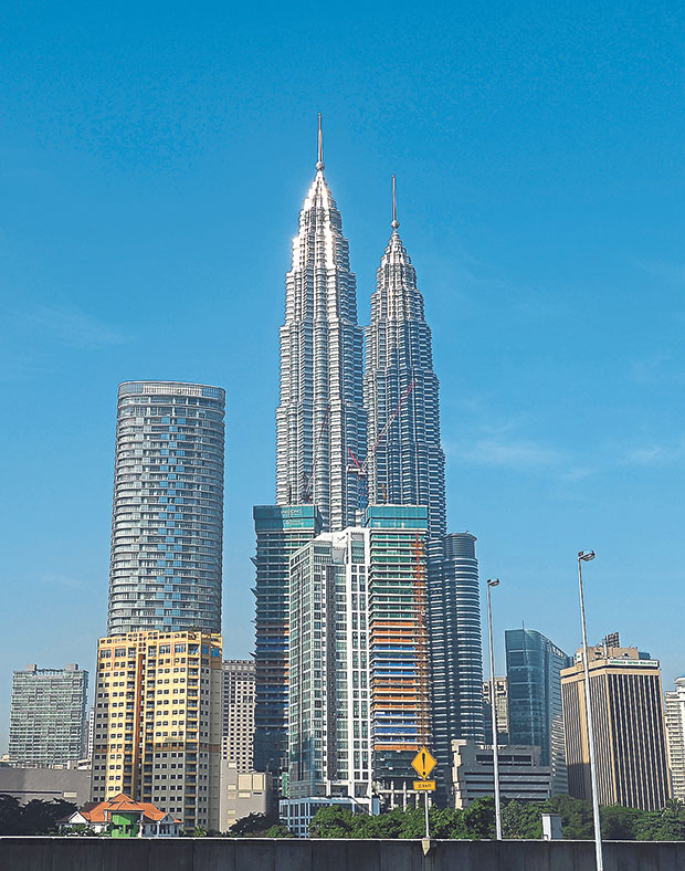 Driving from Singapore to the heart of Kuala Lumpur — as seen here in this picture of the iconic Petronas Twin Towers — is really not a hassle as the writer found out.  – Picture by AFP