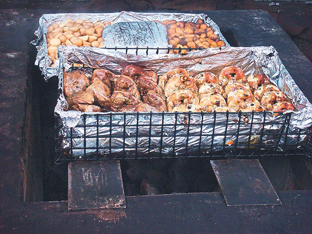 Food being cooked over a hangi, an ‘earth oven’ that has been used by the Maoris for centuries