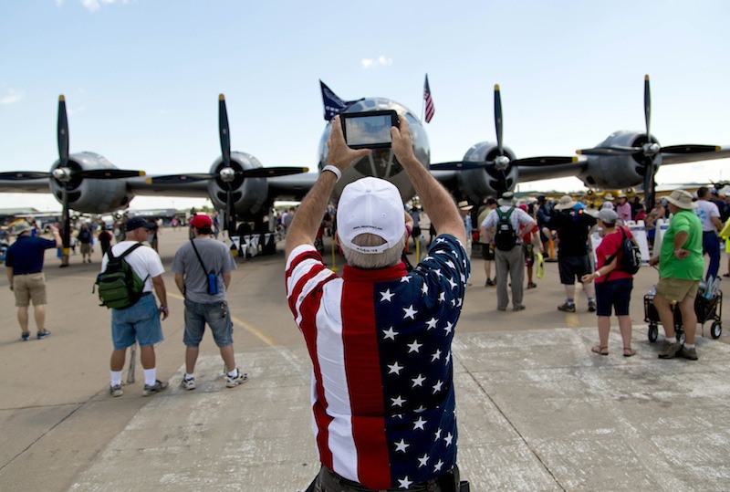 A man takes a photo of an American World War II bomber at the EAA AirVenture at Wittman Regional Airport in Oshkosh, Wisconsin August 3, 2013. u00e2u20acu201d Reuters pic