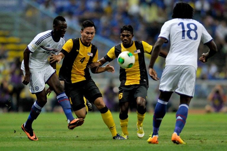 Chelsea's Bertrand Traore (left) vies for the ball with with Malaysia's Asraruddin Putra Omar (2nd left) and S. Kunanlan (2nd right) in front of Chelsea's Romelu Lukaku (right) during their friendly football match in Shah Alam, on July 21, 2013. u00e2u20acu201d AFP p