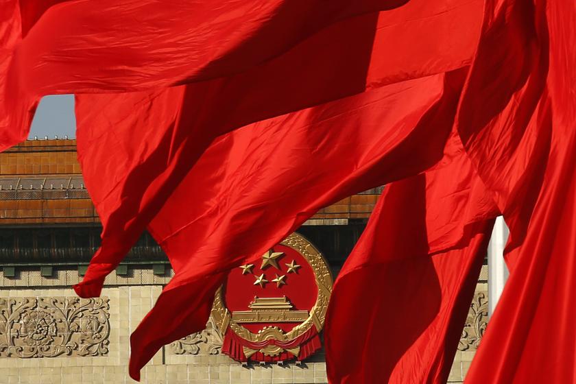The Great Hall of the People, where the Chinese Communist Party plenum is being held, is seen behinds red flags in Tiananmen square in Beijing November 12, 2013.