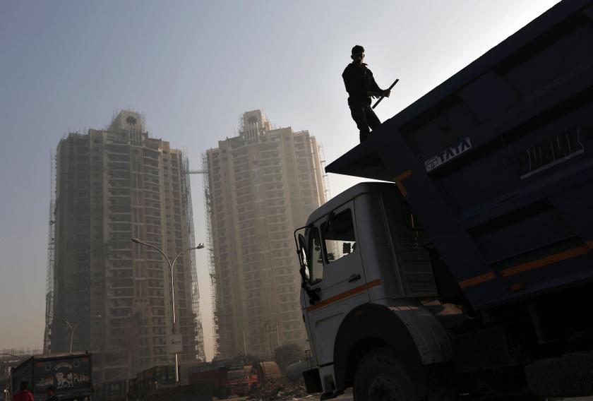 A labourer stands on a truck carrying construction materials at a construction site of residential buildings in Noida on the outskirts of New Delhi November 29, 2013. u00e2u20acu201d Reuters pic