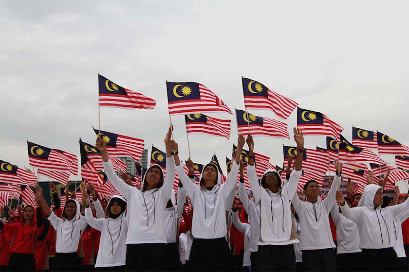 A student waves a Malaysian flag during the rehearsal for Merdeka Day celebrations at Dataran Merdeka, Kuala Lumpur, August 28, 2014. — Picture by Yusof Mat Isa