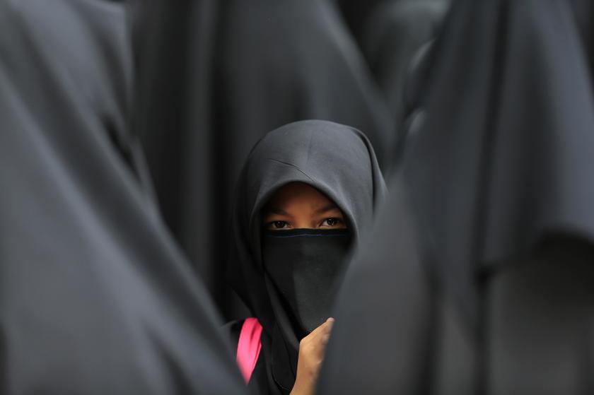 A girl wearing a hijab waits at the Shah Alam stadium during celebrations of Maulidur Rasul, or the birth of Prophet Muhammad, outside Kuala Lumpur January 14, 2014. u00e2u20acu201d Reuters pic