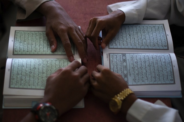 Malaysian Muslim boys read the Quran during a Quran lesson at a mosque in Ampang, in the suburbs of Kuala Lumpur on July 30, 2013. u00e2u20acu201d AFP pic