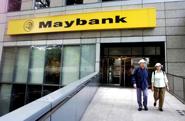 A couple walks out from a branch of the Malayan Banking Bhd (Maybank), Malaysiau00e2u20acu2122s biggest bank, in Kuala Lumpuru00e2u20acu2122s financial district, on September 27, 2001. u00e2u20acu201d AFP pic