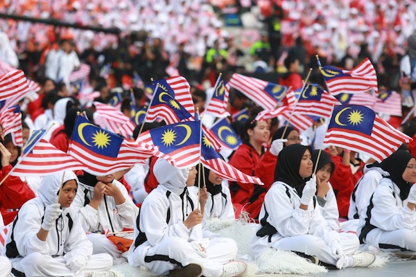 Participants wave flags during the 56th National Day Parade at Dataran Merdeka in Kuala Lumpur, August 31, 2013. u00e2u20acu201d Picture by Saw Siow Feng