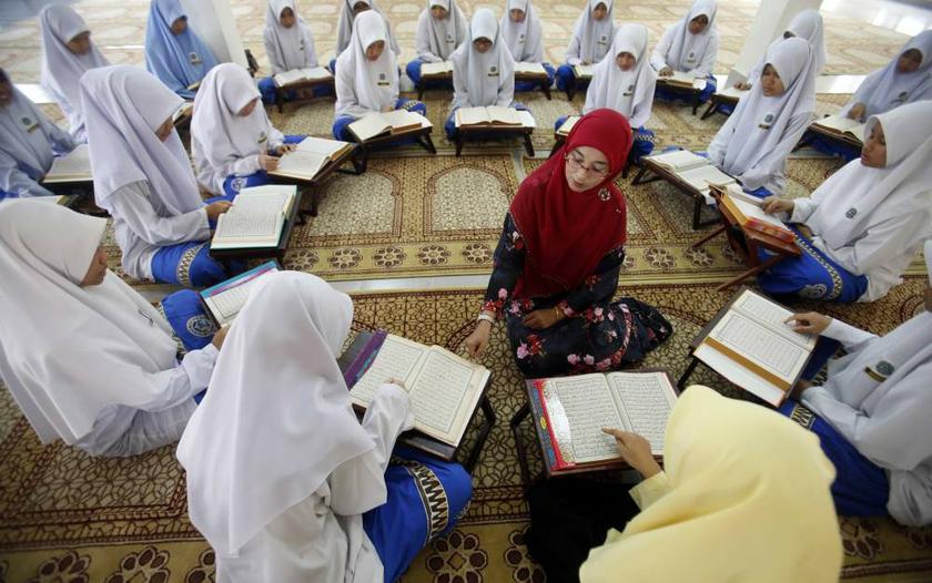 Muslim schoolgirls sit in a circle around their religious teacher as they recite verses from the Quran on the occasion of u00e2u20acu02dcNuzul Quranu00e2u20acu2122 in Putrajaya on July 26, 2013. u00e2u20acu201d Reuters pic