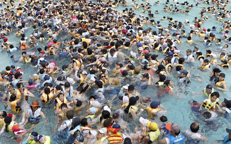 South Koreans swim at Caribbean Bay swimming pool in South Koreau00e2u20acu2122s largest amusement park Everland in Yongin, about 50km south of Seoul August 11, 2013. u00e2u20acu201d Reuters pic