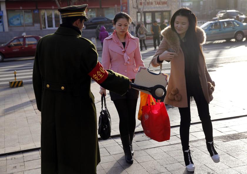A security officer scans a pedestrian with a detector on a street in Urumqi, Xinjiang Uighur autonomous region, November 17, 2013. u00e2u20acu201d Reuters pic